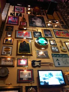 the wall is covered with many framed pictures