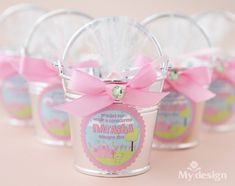 small candy jars with pink bows on them