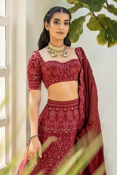 Maroon attached cancan lehenga with floral patterns chikankari embroidery and sequin highlights. Comes with embroidered blouse and dupatta.
Components: 3
Pattern: Embroidered
Type Of Work: Chikankari
Neckline: Sweetheart
Sleeve Type: Short
Fabric: Georgette
Color: Maroon
Other Details: 
Back tie-up blouse
Scalloped embroidered border dupatta
Lehenga length: 45 inches
Occasion: Wedding - Aza Fashions Embroidered Bridal Lehenga, Cancan Lehenga, Chikankari Embroidery, Embroidered Border, Sweetheart Neck, Bridal Lehenga, Embroidered Blouse, Floral Patterns, Set For Women