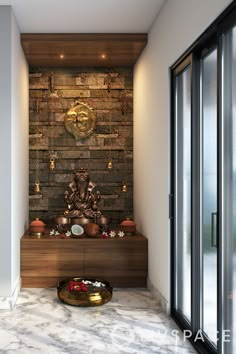 a buddha statue sitting on top of a wooden shelf in front of a brick wall