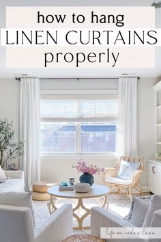 a living room with white furniture and curtains