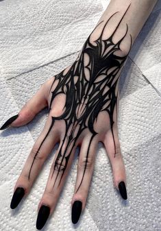 a woman's hand with black ink on it