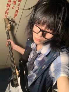 a person with glasses and a guitar