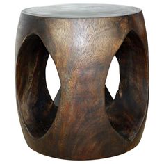 a wooden stool with two holes in the middle and one hole at the top that is shaped like an elephant's head