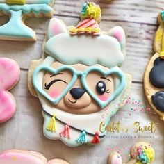 some decorated cookies are on a table with other items in the shape of teddy bears