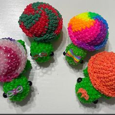 there are four balls made to look like turtles on the table, each with different colors and sizes