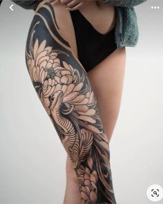 a woman's leg with tattoos on it