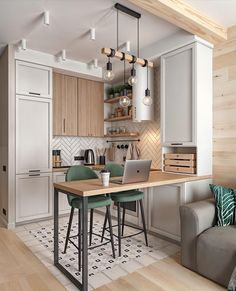 an open concept kitchen and living room with laptop on the dining table in front of the couch