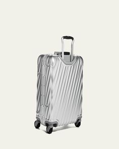 Carryon made of aluminum. 16"W x 9"D x 22"T. Imported. Silver Rectangular Luggage With Sleeve, Carry On Luggage, Bergdorf Goodman, Top Designers, Carry On, Tops Designs, Free Shipping, Design