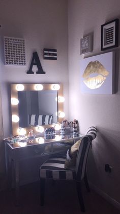 a vanity with lights on it and a chair in front of the mirror that is lit up