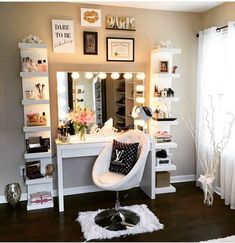 a room with a vanity, mirror and lights on the wall next to a window