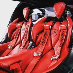 the interior of a sports car with red leather seats