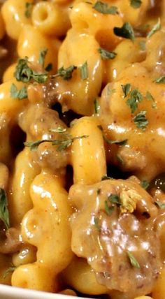 a close up of a plate of macaroni and cheese covered in gravy