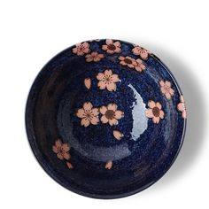 a blue bowl with pink flowers on it