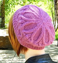 a woman wearing a purple knitted hat