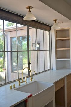 a kitchen with a sink, window and cabinets in it's center island area