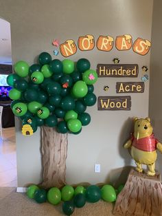 winnie the pooh balloon decoration in front of a tree