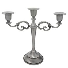 a metal candelabra with three candles on it