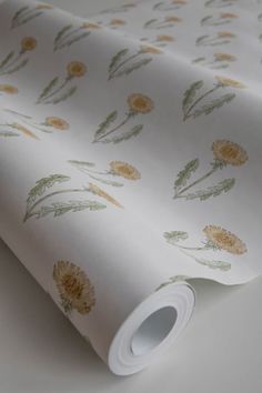 a white wallpaper with yellow flowers and green leaves on the bottom half of it