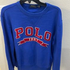 Royal Blue Polo 1967 Ribbon Sweatshirt. The Colors On This Shirt Are Excellent Condition. Looks Brand New. Blue Crew Neck Sweatshirt With Embroidered Logo, Blue Casual Top With Embroidered Logo, Casual Blue Tops With Embroidered Logo, Casual Blue Top With Embroidered Logo, Blue Logo Print Sweater For Fall, Blue Cotton Sweater With Embroidered Logo, Fall Blue Sweater With Logo Print, Blue Long Sleeve Sweatshirt With Embroidered Logo, Blue Long Sleeve T-shirt With Embroidered Logo