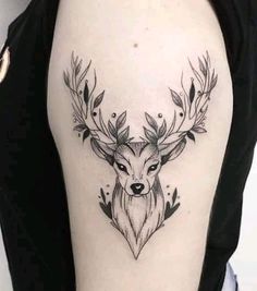 a woman's arm with a deer head and leaves tattoo on the left side