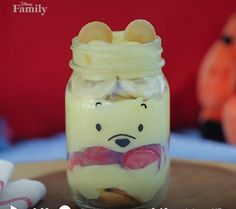 a glass jar filled with pudding and marshmallows sitting on top of a table