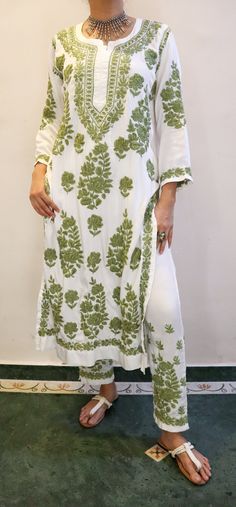 Elevate your style with our exquisite AYZA Satin Silk Kurta Set in pristine white, adorned with intricate Premium Chikankari embroidery in contrasting hues.  This ensemble embodies elegance and sophistication, offering a perfect blend of luxurious comfort and traditional artistry.  Whether it's a festive occasion or a special event, this ensemble promises to make you the center of attention, showcasing the timeless charm of Chikankari on a backdrop of lustrous satin silk.  Length of kurta - 47 inches Pockets on the Pants 100% colorfast. Prewashed. Preshrunk.  Wash in cold water with mild detergent. Line dry and steam iron for best results. Sizes -  S - fits bust 34 M - fits bust 36 L - fits bust 38 XL - fits bust 40 0X - fits bust 42 1X - fits bust 44 Spring Embroidered White Traditional Wear, White Traditional Wear For Spring, Unstitched White Traditional Wear For Spring, White Traditional Wear With Floral Embroidery For Spring, Elegant Long Traditional Wear With Floral Embroidery, White Salwar Kameez With Floral Embroidery For Transitional Seasons, Elegant White Mulmul Kurta, Elegant Floral Embroidered Salwar Kameez For Traditional Ceremonies, Transitional White Salwar Kameez With Floral Embroidery