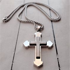 Stainless steel necklace with a black cross made of satin black enamelled steel. The cross has a length of 10 cm and a width of 4 cm. One of the faces of the cross has an inscribed prayer and a cross. The chain  is made of stainless steel, 50 cm long and 3 mm wide, with a safety pin closure. A design that contrasts the natural shine of steel and the reflective dark shine of the cross. Easily combinable with models from our catalog in steel and silver. When buying jewelry in contact with the skin Cross Pendant For Men, Cross Necklace Men, Stainless Steel Cross Pendant, Mens Earrings Hoop, Pendant For Men, Steel Cross, Necklace Men, Silver Cross Pendant, Black Cross