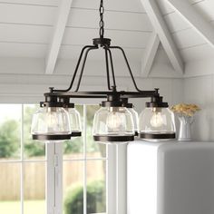 three lights hanging from the ceiling in a kitchen