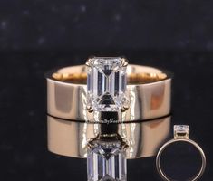 an emerald cut diamond ring and matching wedding band are shown with the engagement ring in gold