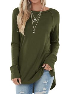 a woman wearing a green top with ripped jeans and necklaces on her neck,