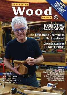 the front cover of wood review magazine featuring an image of a man holding a piece of wood