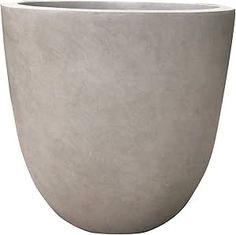 a large white planter sitting on top of a table