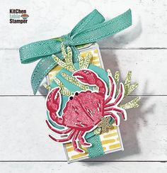 a card with a crab on it and a green ribbon around the edge that says, kitchen stamper