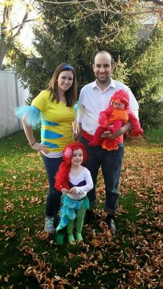 a man, woman and child dressed up in costumes