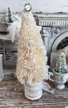 a white christmas tree sitting on top of a table