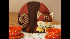 a stuffed animal sitting on top of a table next to a cup and saucer