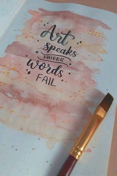 an art speaks where words fail written on a notebook with a pen next to it