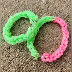 two different colored bracelets sitting on the ground