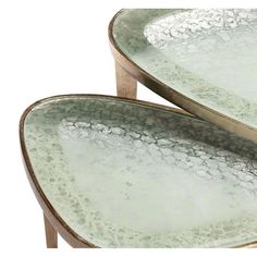 two oval glass tables with metal bases