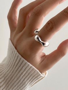 Editor's Notesmoire_ presents a wavy ring with plump silhouette. It is a unique ring that you can wear daily and layer on other rings. - Wavy open shape- Glossy surface- Made of silver 925- Plump silhouette- Sophisticated and unique moodMeasurements(in.)- One Size Composition & Care- Material: Silver 925- Plated products may discolor over time due to their nature.- Please be careful that discoloration may proceed faster in chemical substances, water, and heat.- As all jewelry produ Modern Irregular Metal Ring Jewelry, Adjustable Bypass Ring With Modern Twist, Midi Rings With Open Band And Modern Twist, Modern Twist Midi Rings With Open Band, Modern Twist Adjustable Bypass Ring, Modern Adjustable Rings With Irregular Shape, Elegant Irregular Rings For Gifts, Modern Adjustable Irregular Rings, Trendy Adjustable Irregular Rings