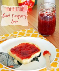 homemade fresh raspberry jam in a jar on a plate next to a sandwich