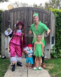 a man and two children are dressed up as tinkerbells