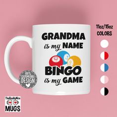 a white coffee mug with the words grandma is my name and two balls on it