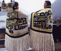 two women in native clothing standing next to each other