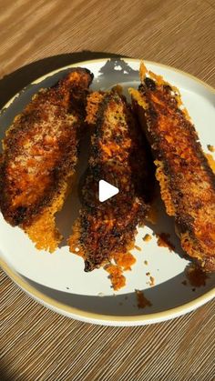 fried food on a white plate with a wooden table