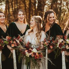 a group of women standing next to each other holding bouquets