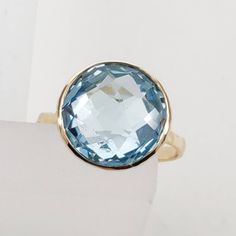 **KINDLY CHECK OUT THE VIDEO OF THE ITEM FOR A CLEARER VIEW**Details of the ring Gem: Sky Blue topaz Gem size: 12x12 mm Gem weight: 7.35 carats Gold purity: 14KT (58.33% approx.) Gold weight: 1.69 gms total weight of ring: 3.16 gms Checkerboard cut Sky blue topaz gemstones set in solid 14KT yellow gold. The Gold purity is guaranteed and it comes with authentic 14 kt gold hallmark. Since these Rings are handmade, Size Customization is available for this ring and it is available in all ring sizes. Faceted Blue Topaz Ring, Blue Faceted Sapphire Ring In Fine Jewelry Style, Blue Faceted Sapphire Ring Fine Jewelry, Faceted Blue Topaz Ring In Fine Jewelry Style, Blue Topaz Round Ring In Fine Jewelry Style, Blue Faceted Topaz Ring For Anniversary, Blue Topaz Ring With Vs Clarity For Gift, Blue Topaz Ring With Vs Clarity As Gift, Faceted Topaz Ring In 14k Gold As Gift