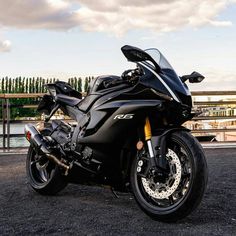 a black motorcycle parked on top of a parking lot