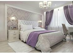 a bedroom with purple and white decor in the corner, along with a chandelier